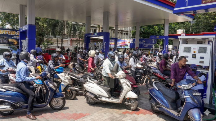 Crowded petrol pump in India with long queues, no stock signs, and panic buying caused by fuel shortage rumors